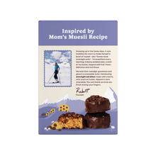 Front of Cookie Dough Bites box showing headline 'Inspired by Mom's Muesli Recipe' and chocolate-dipped oat bites on a purple mountain background